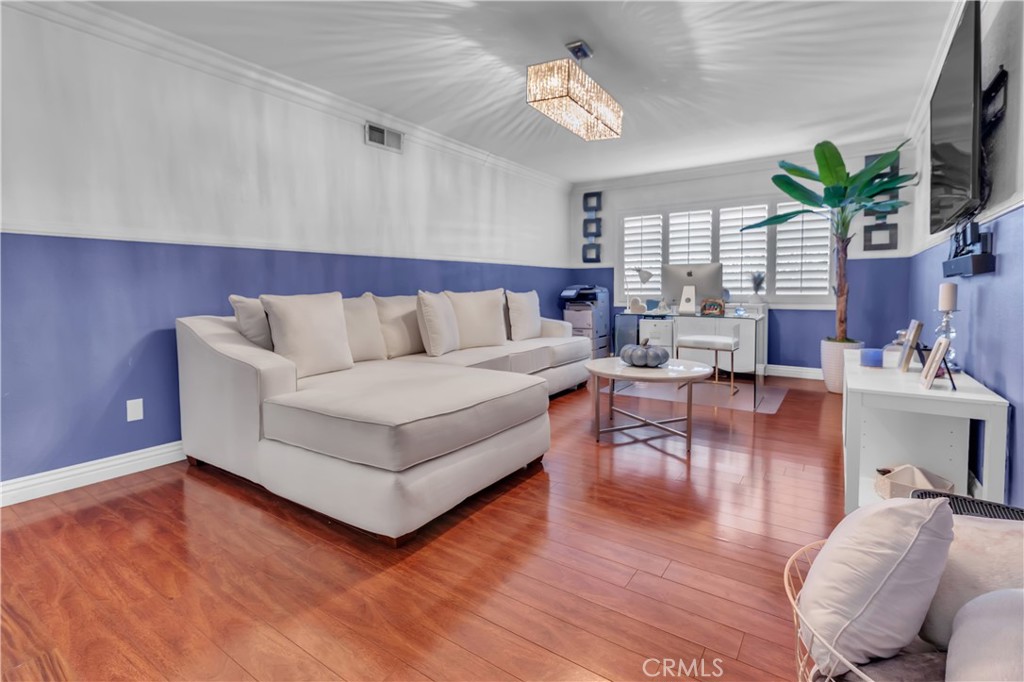 1324 East Turmont Street Carson, CA 90746 - Photo 9 of 47 a living room with furniture wooden floor and a flat screen tv