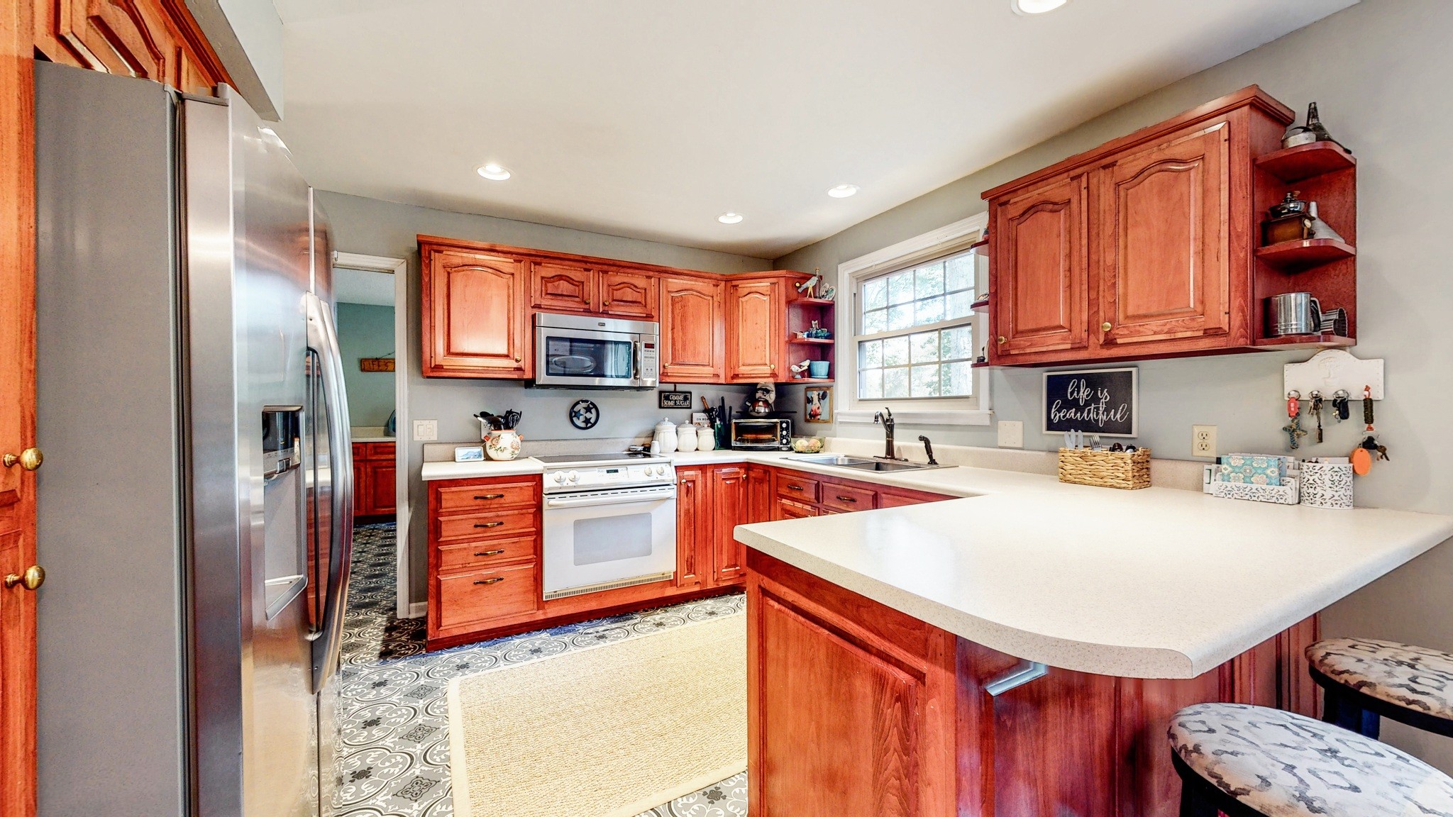 1751 Cooks Road Mount Juliet, TN 37122 - Photo 8 of 36 a kitchen with stainless steel appliances a refrigerator a stove a sink cabinets and a dining table