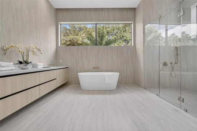 a bathroom with a bathtub and shower