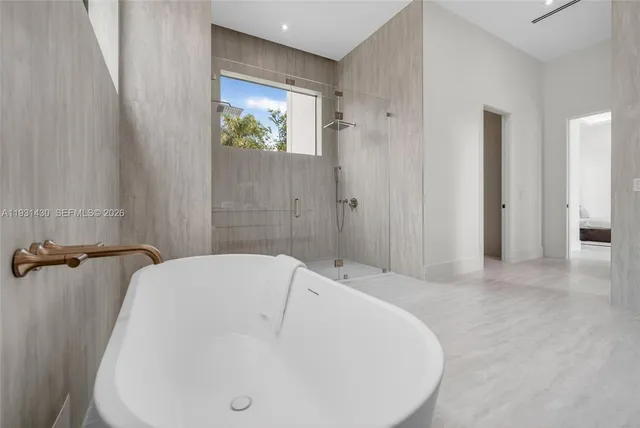a view of kitchen with cabinets and window