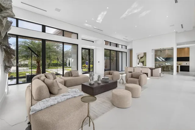 a living room with furniture and a floor to ceiling window