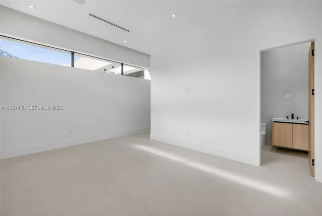 a work room with furniture and a flat screen tv