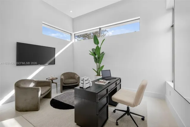 a living room with furniture potted plant and a large mirror