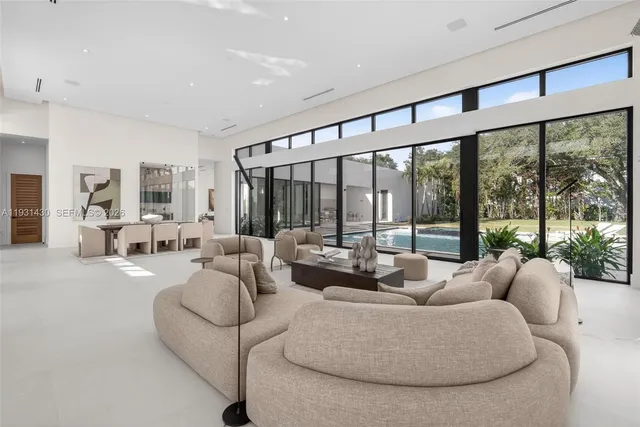 a room with stainless steel appliances kitchen island granite countertop furniture and a large window