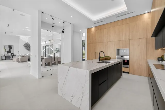 a kitchen with counter top space and living room