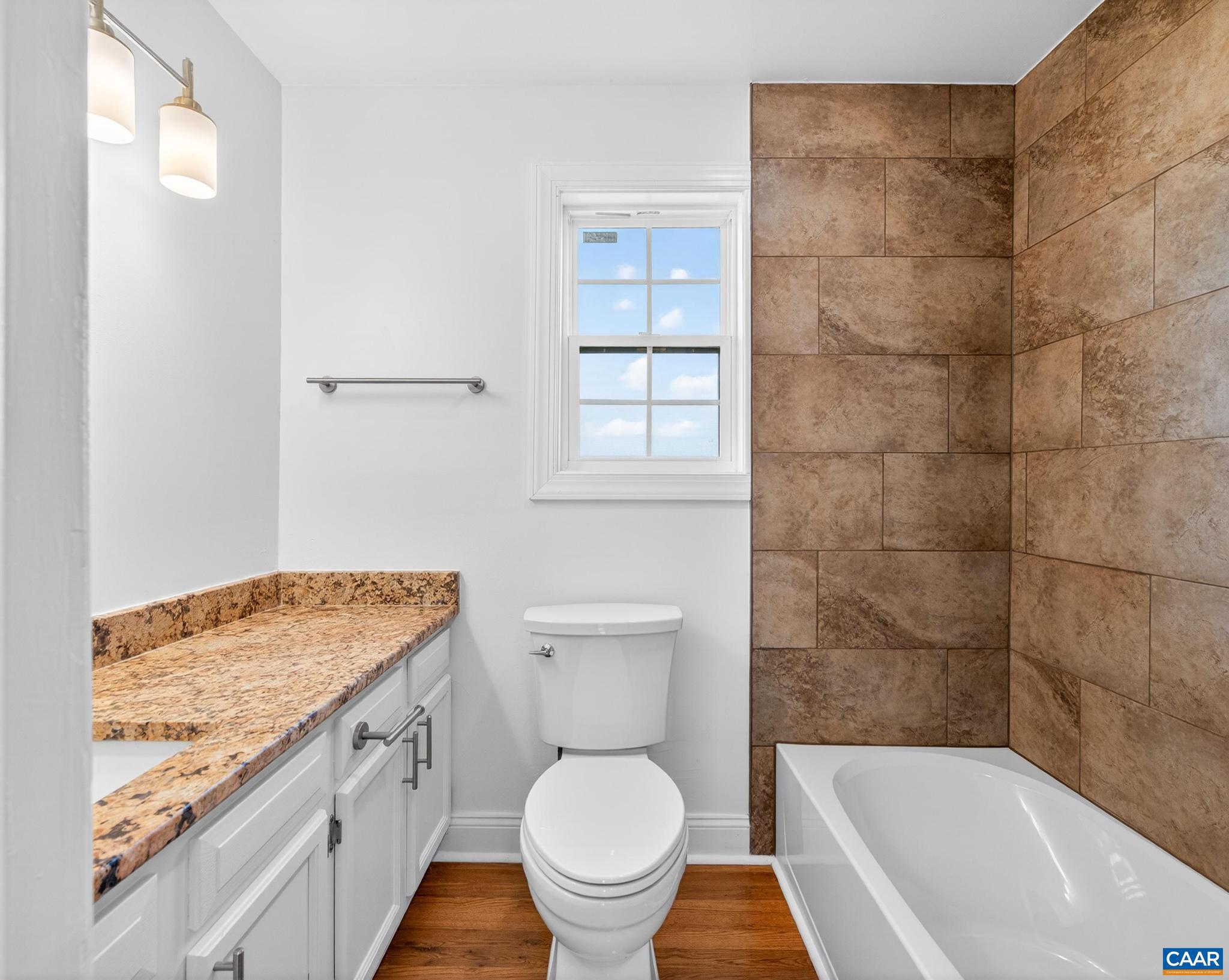 481 Race Ground Road Somerset, VA 22972 - Photo 43 of 53 a bathroom with a granite countertop toilet a sink and a bathtub
