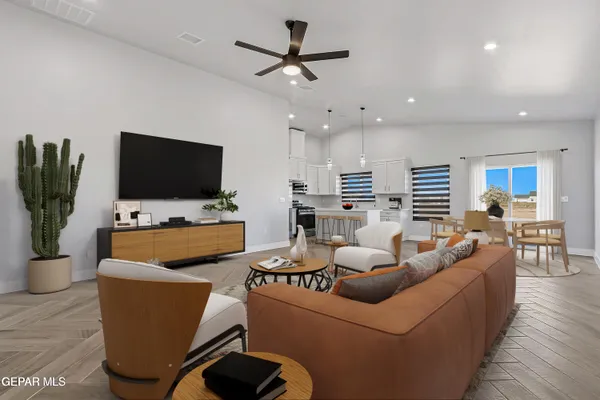 an empty room with wooden floor and a ceiling fan