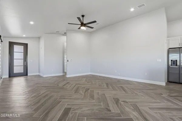 an entryway with kitchen and windows