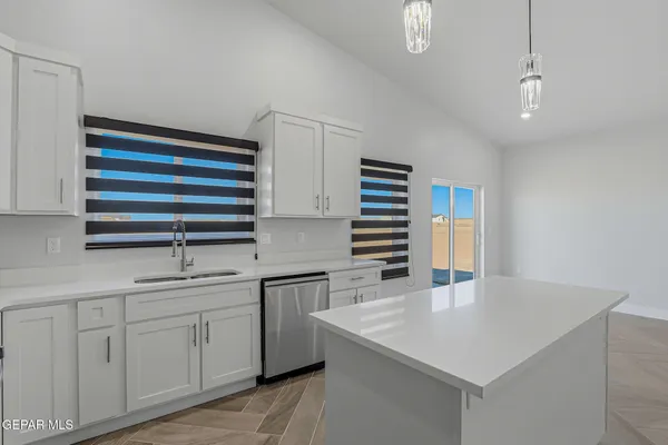 a kitchen with stainless steel appliances a refrigerator and a stove top oven