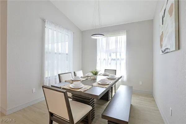 a dining room with furniture and window