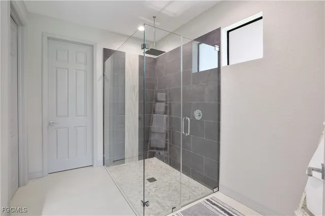 a bathroom with a shower and a glass door