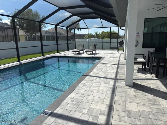 a view of a patio with a table and chairs under an umbrella