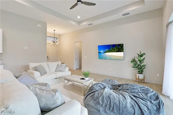 a living room with furniture and a potted plant