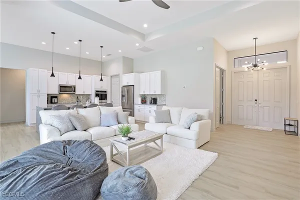 a living room with furniture and kitchen view