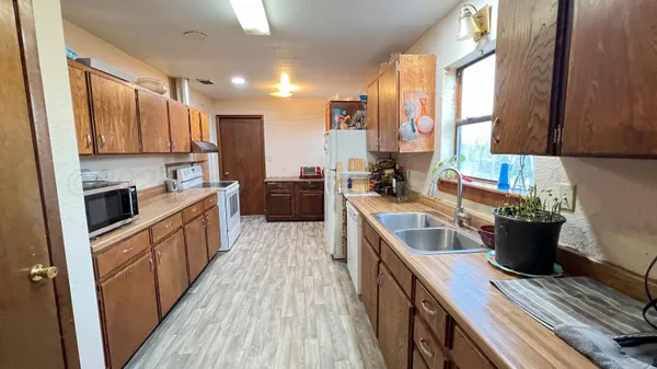 a kitchen with a sink stove and cabinets