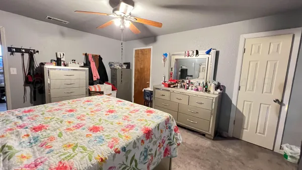a bedroom with a bed closet and flat screen tv