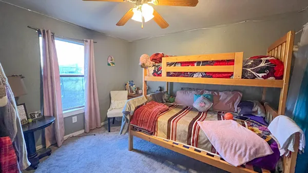 a bedroom with a bed and dresser