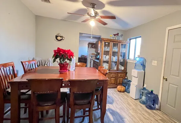 a view of a dining room with furniture and wooden floor