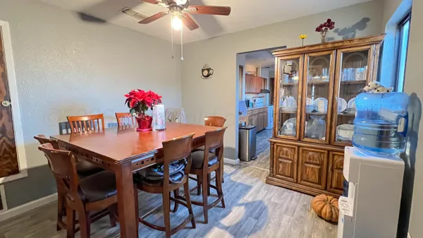 a view of a dining room with furniture wooden floor and chandelier