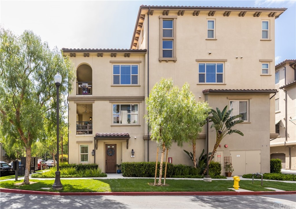 a view of a white building among the street and palm trees