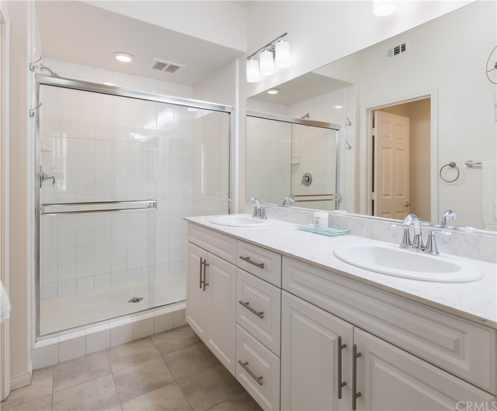 75 Plateau Irvine, CA 92618 - Photo 15 of 29 a bathroom with a double vanity sink mirror and shower