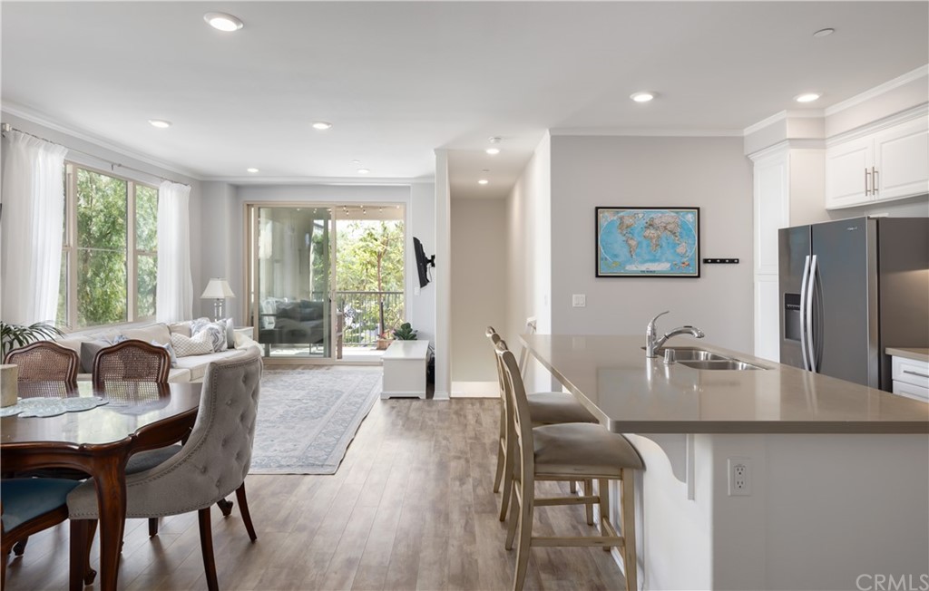 75 Plateau Irvine, CA 92618 - Photo 7 of 29 a dining room with furniture a large window and stainless steel appliances