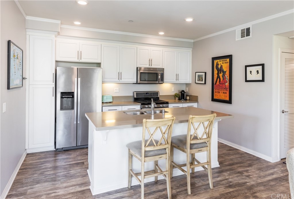 75 Plateau Irvine, CA 92618 - Photo 9 of 29 a kitchen with stainless steel appliances granite countertop a refrigerator and a stove top oven