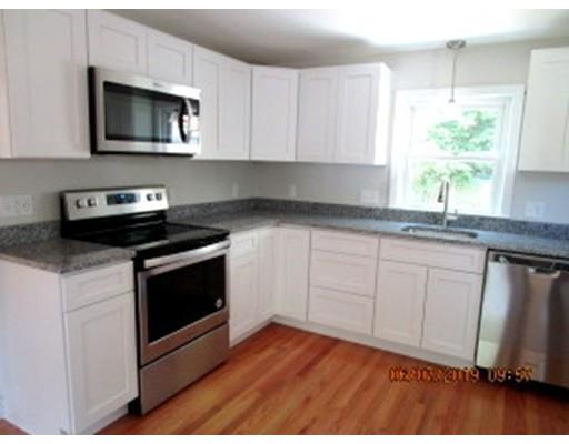 47 2nd Island Road Webster, MA 01570 - Photo 8 of 26 a kitchen with granite countertop white cabinets appliances a sink and a window