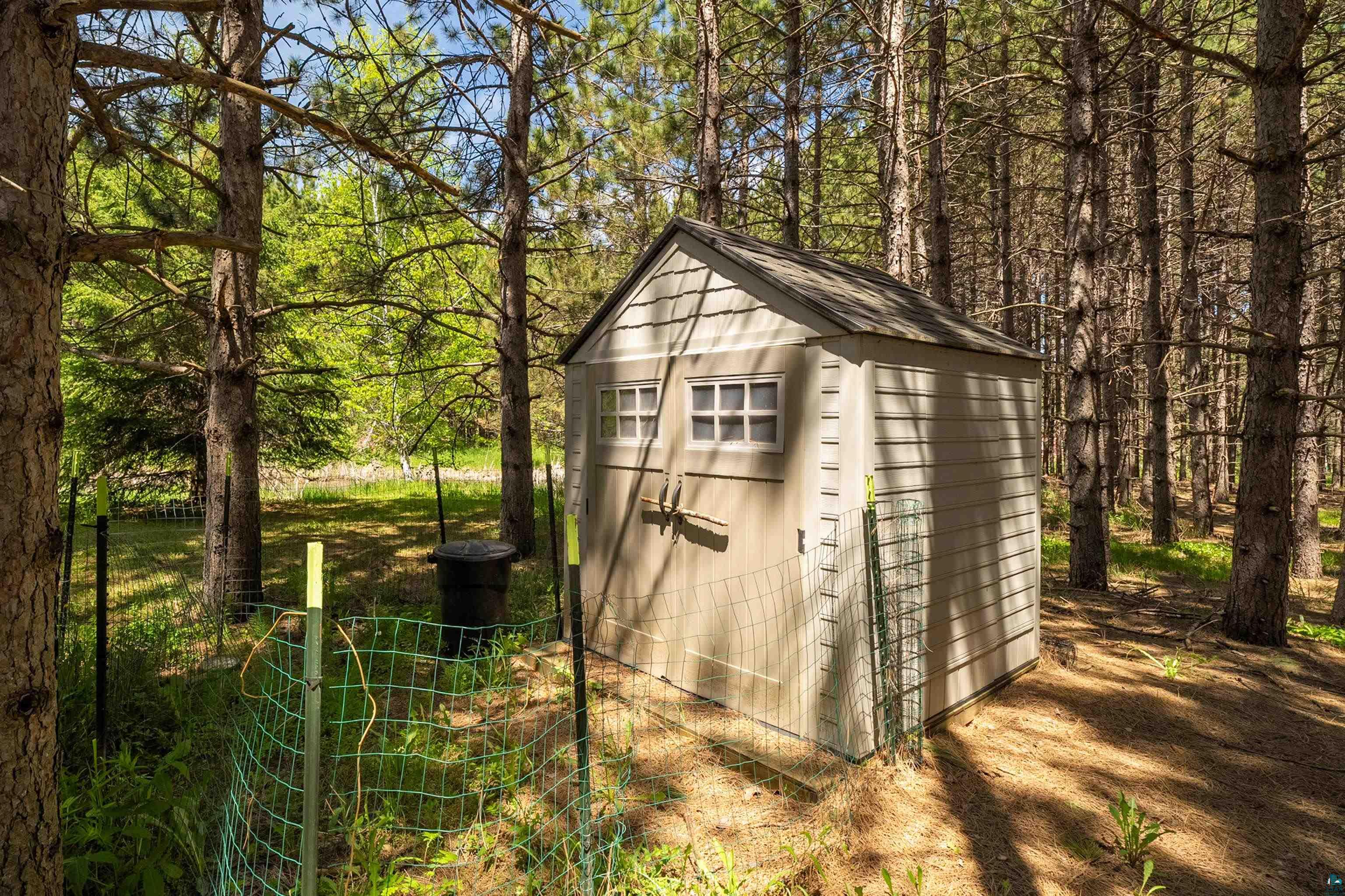 75 East Stark Road Esko, MN 55733 - Photo 71 of 87 Utility shed with horizontal siding and simulated multi-pane windows, surrounded by mature trees