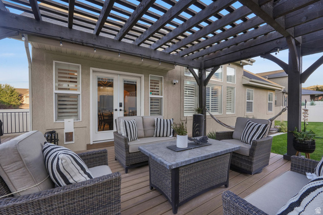 14738 Tangle Hill Road Herriman, UT 84096 - Photo 60 of 66 Spacious outdoor deck featuring a dark wood pergola, wood-finish decking, and double glass doors