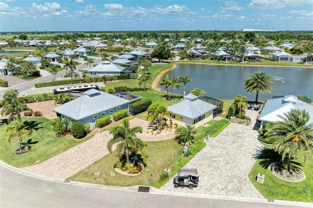 an aerial view of residential houses with outdoor space and lake view