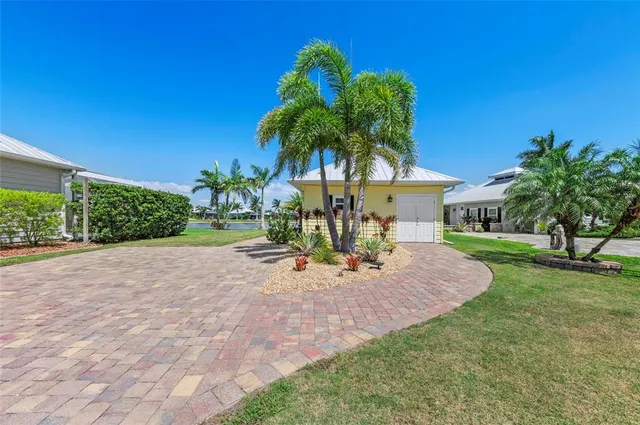 a view of a house with backyard and a tree