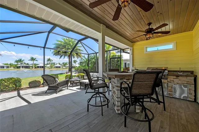 a view of a patio with chairs and table under an umbrella