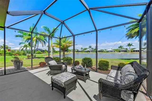 a view of a swimming pool with chairs in patio