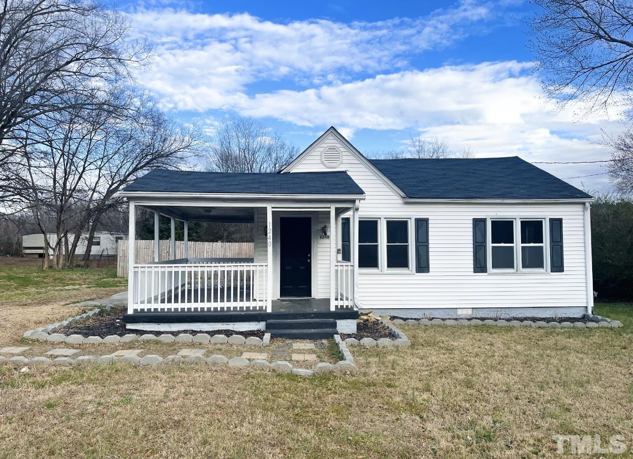 1240 Pointer Street Roxboro, NC 27573 - Photo 1 of 20 a front view of a house with a garden
