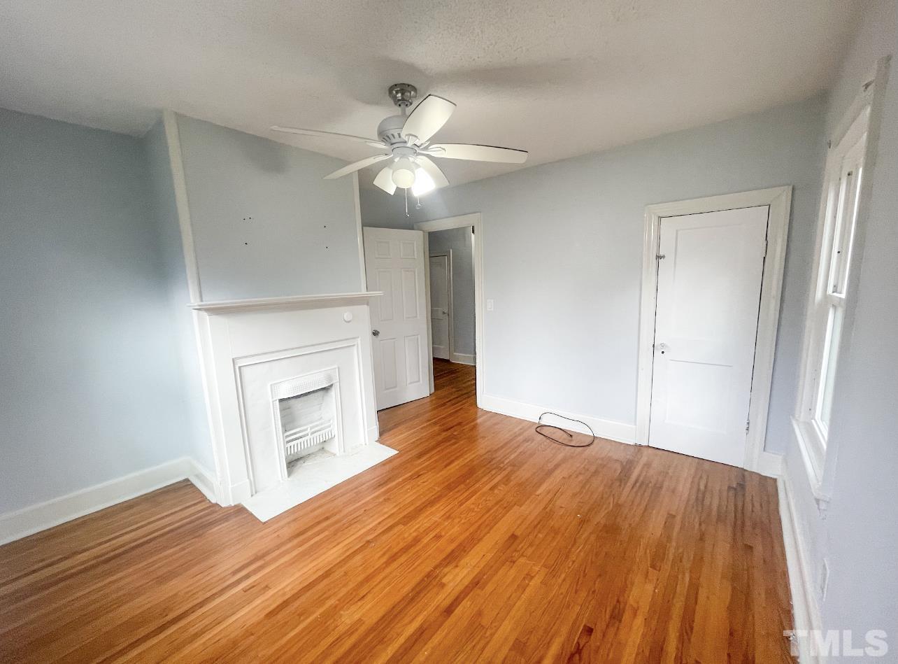1240 Pointer Street Roxboro, NC 27573 - Photo 11 of 20 a view of empty room with wooden floor and fan