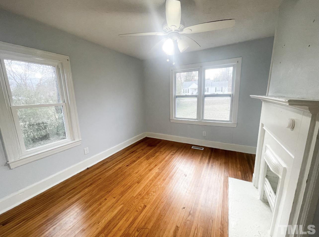 1240 Pointer Street Roxboro, NC 27573 - Photo 12 of 20 an empty room with wooden floor and windows