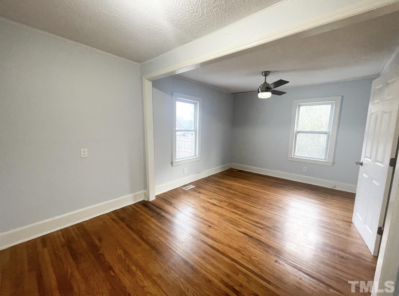 1240 Pointer Street Roxboro, NC 27573 - Photo 15 of 20 an empty room with wooden floor and windows