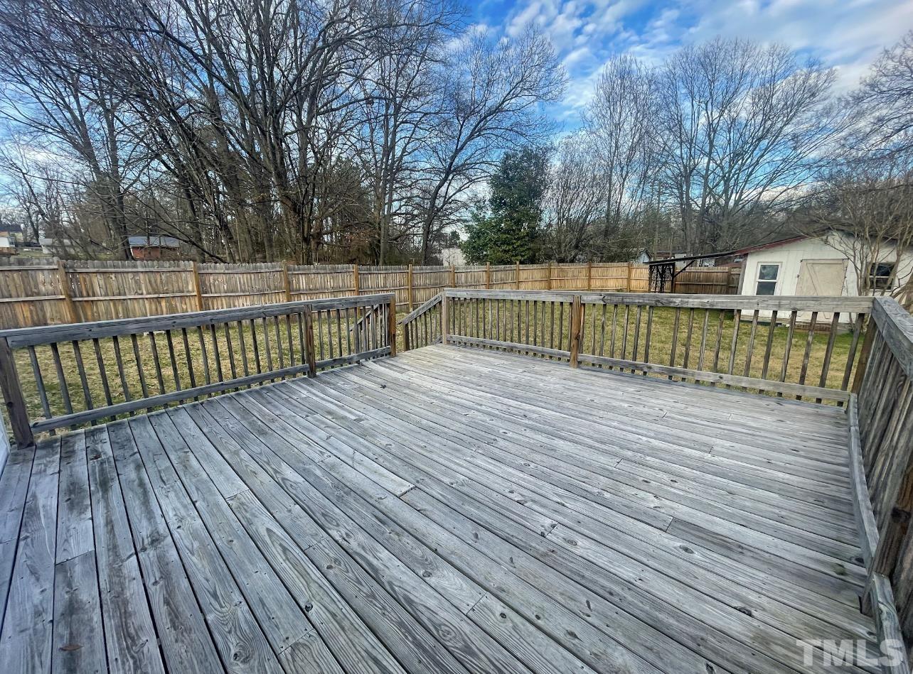 1240 Pointer Street Roxboro, NC 27573 - Photo 18 of 20 a view of deck with wooden floor and fence next to a yard