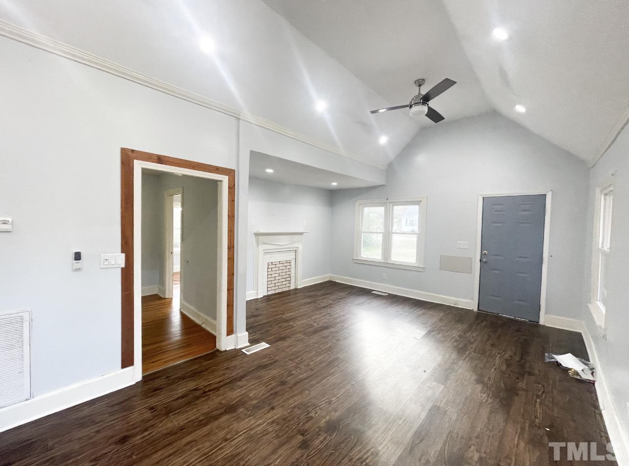 1240 Pointer Street Roxboro, NC 27573 - Photo 6 of 20 an empty room with wooden floor cabinet and windows