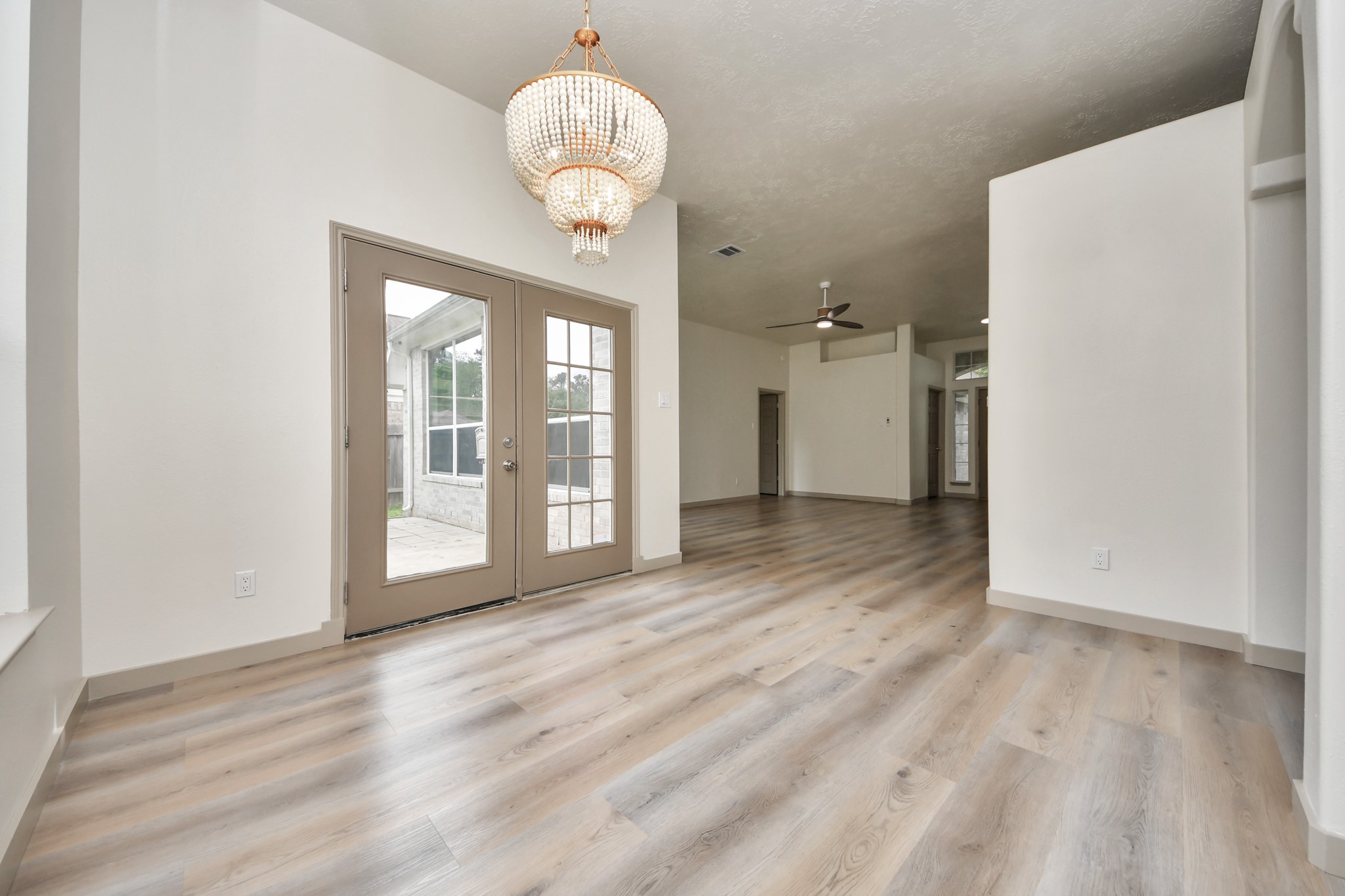 14423 Gadwall Court Houston, TX 77044 - Photo 22 of 42 a view of a room with wooden floor and a large window