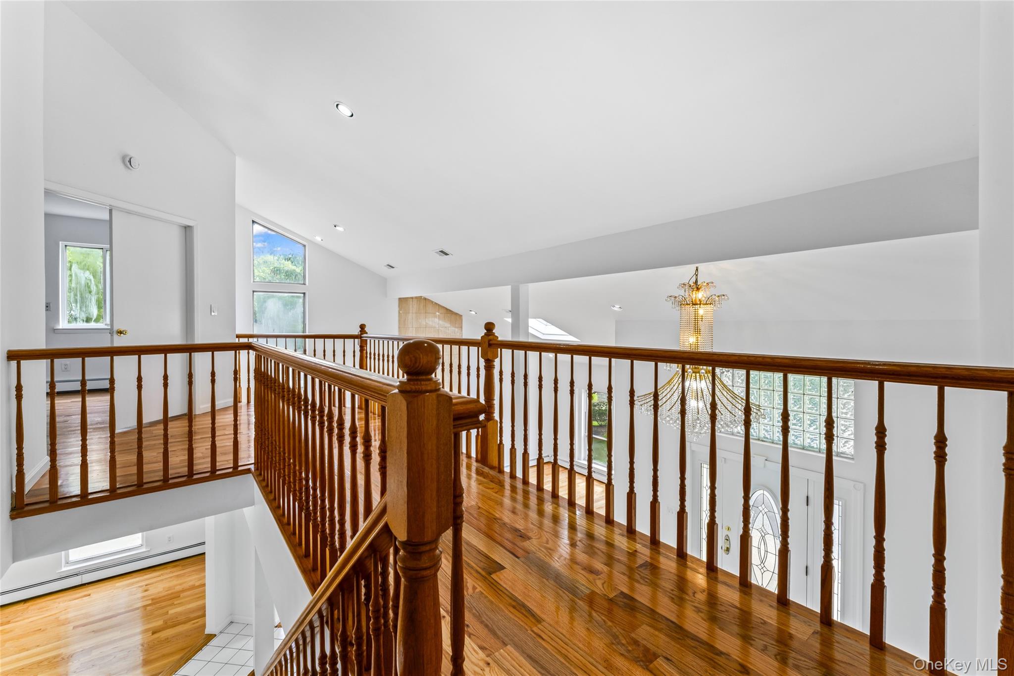 126 Bagatelle Road Melville, NY 11747 - Photo 23 of 50 a view of staircase with lots of wooden floor and windows