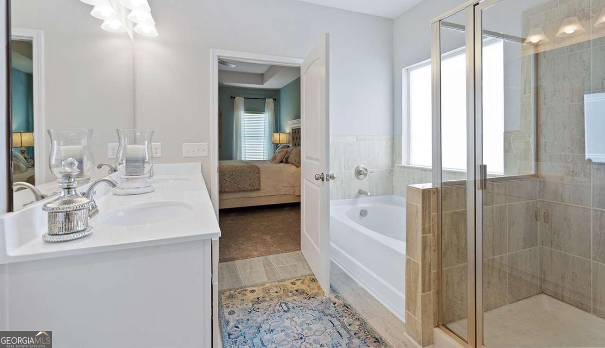 230 Shantz Way Byron, GA 31008 - Photo 2 of 16 a en suite bathroom with a double vanity sink a mirror and a shower