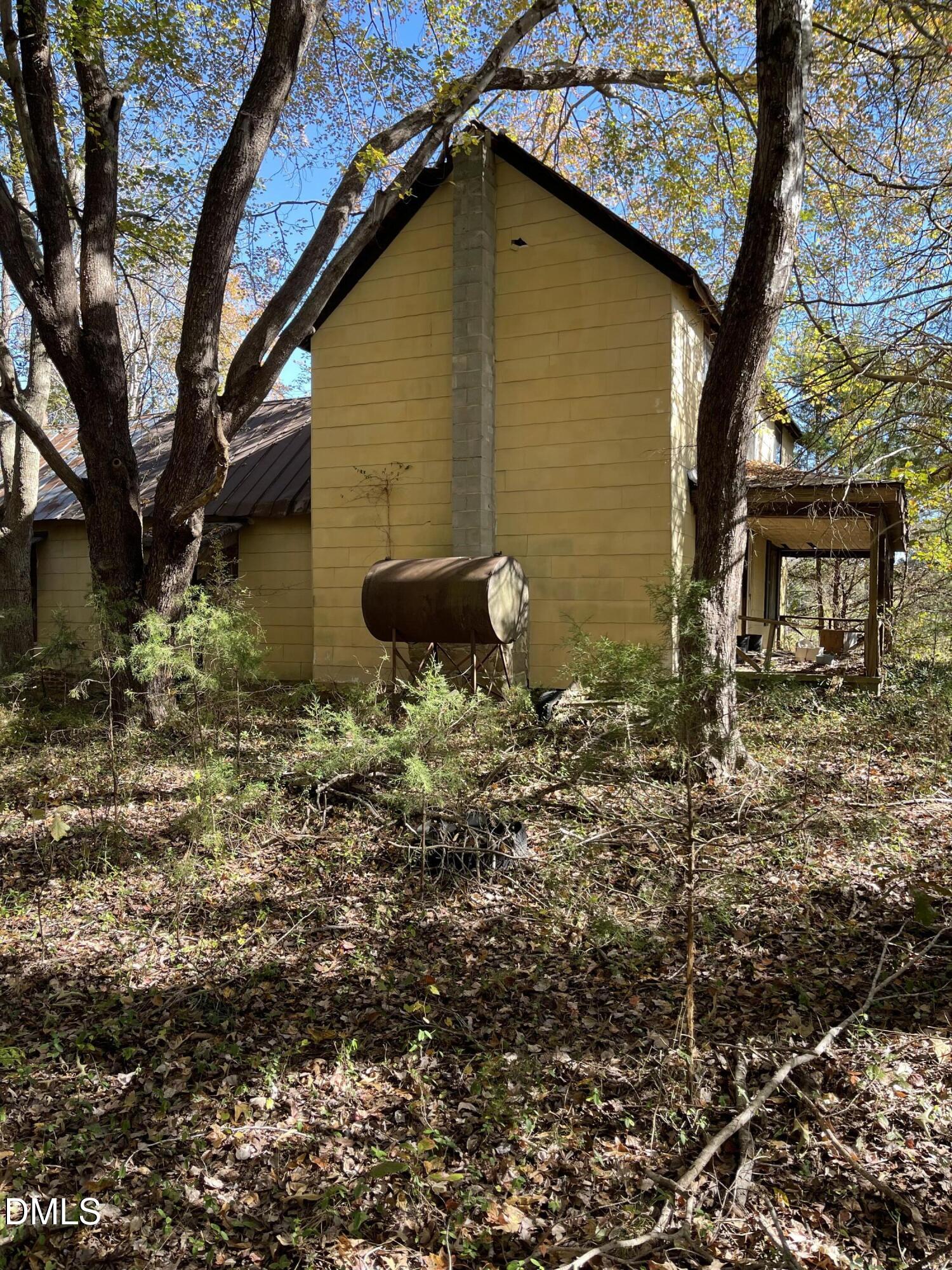 0 Beasley Road Louisburg, NC 27549 - Photo 3 of 10 a backyard of a house with lots of plants and large tree