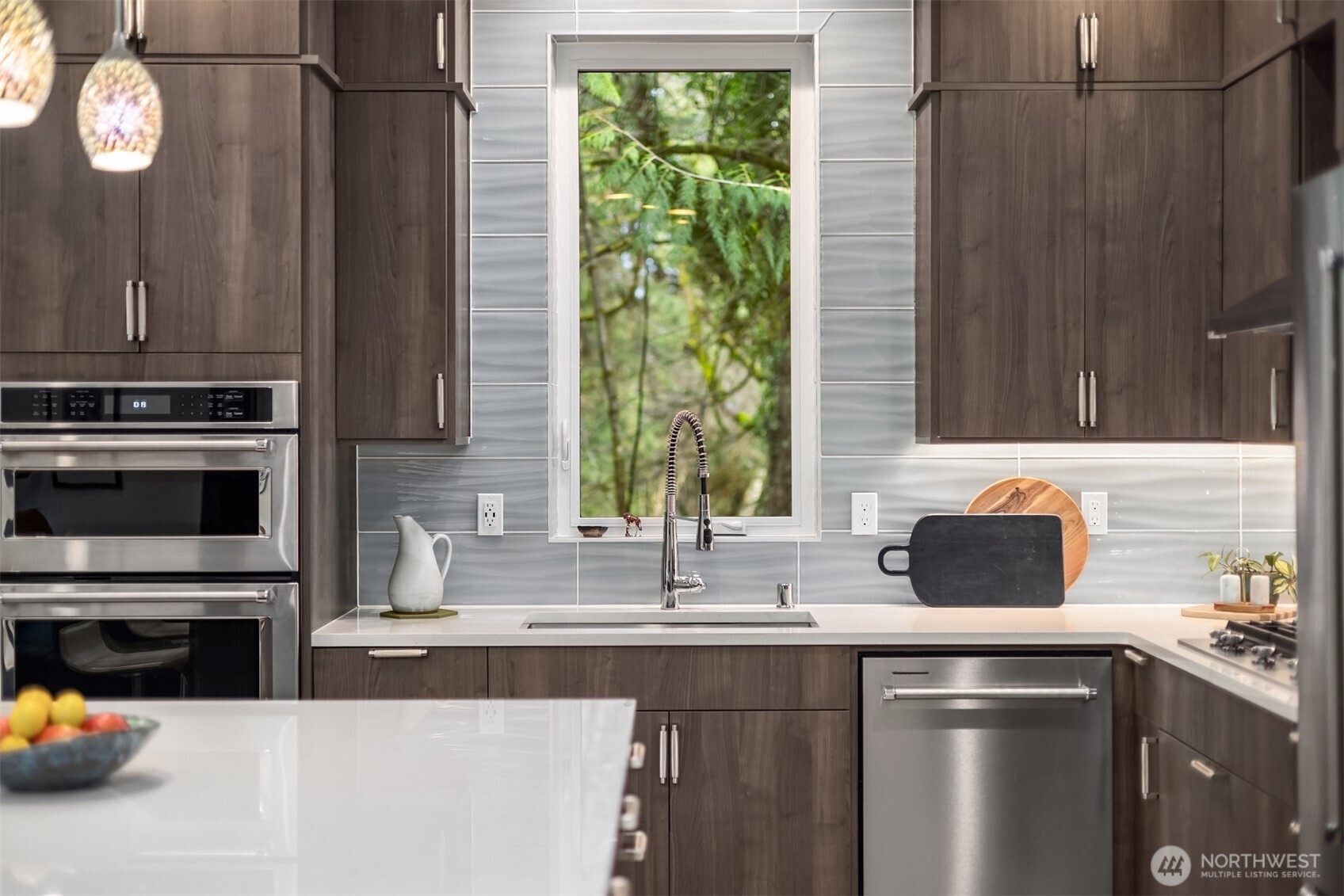 13532 Phelps Road Northeast Bainbridge Island, WA 98110 - Photo 12 of 35 a kitchen with stainless steel appliances a sink a window and cabinets