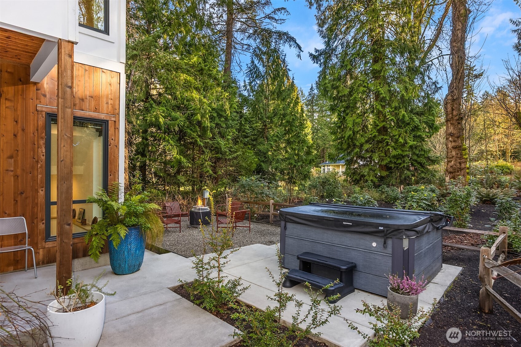 13532 Phelps Road Northeast Bainbridge Island, WA 98110 - Photo 31 of 35 a view of a patio with table and chairs potted plants