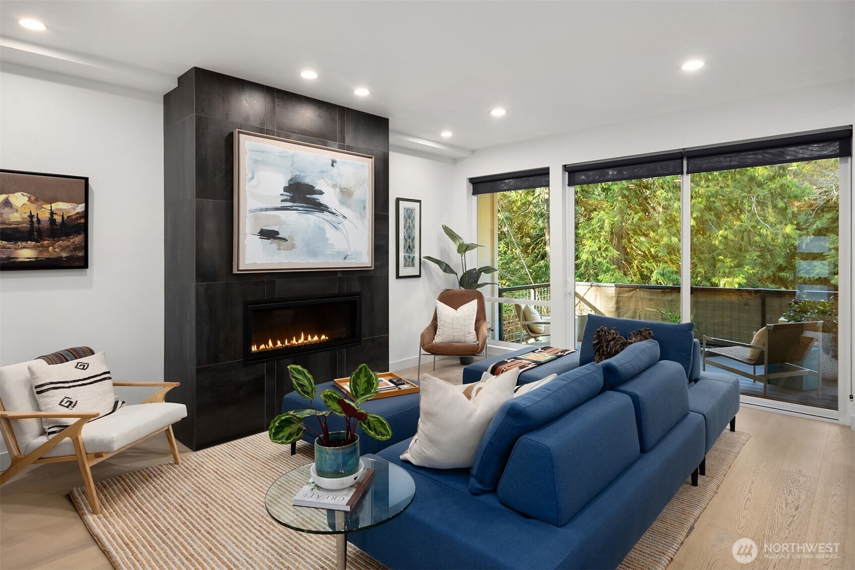 13532 Phelps Road Northeast Bainbridge Island, WA 98110 - Photo 5 of 35 a living room with furniture a fireplace and a floor to ceiling window
