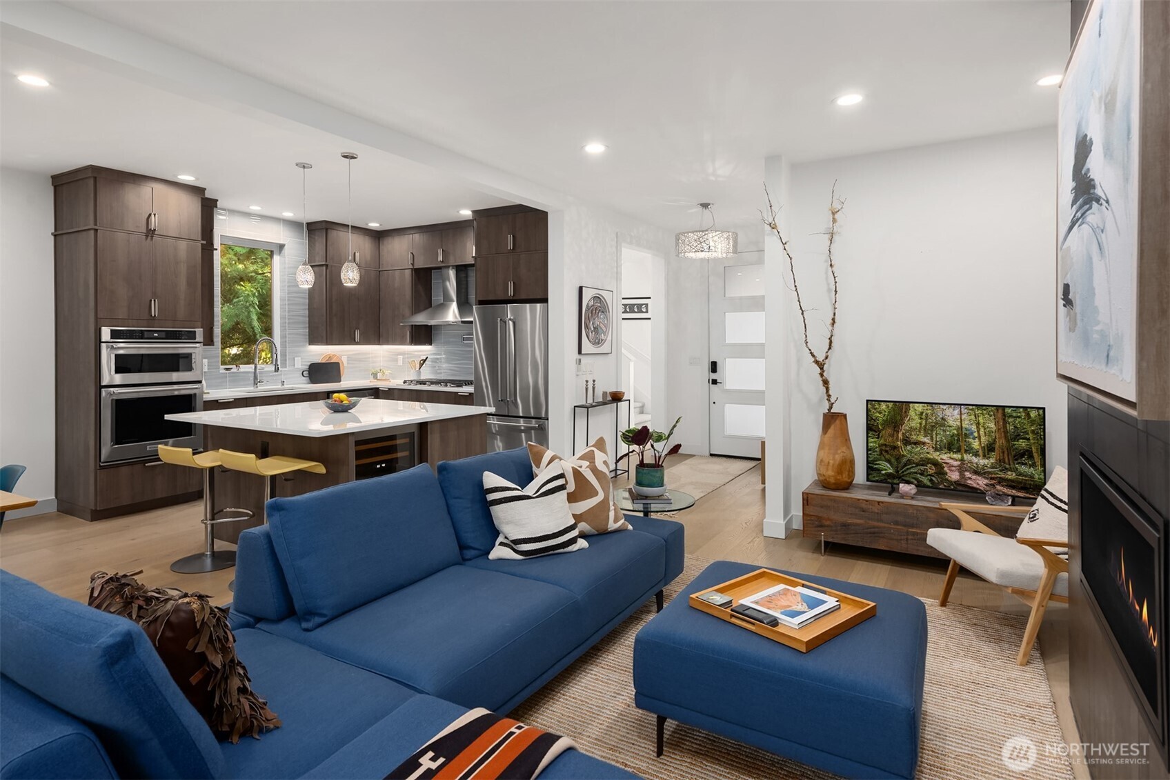 13532 Phelps Road Northeast Bainbridge Island, WA 98110 - Photo 8 of 35 a living room with furniture and a flat screen tv
