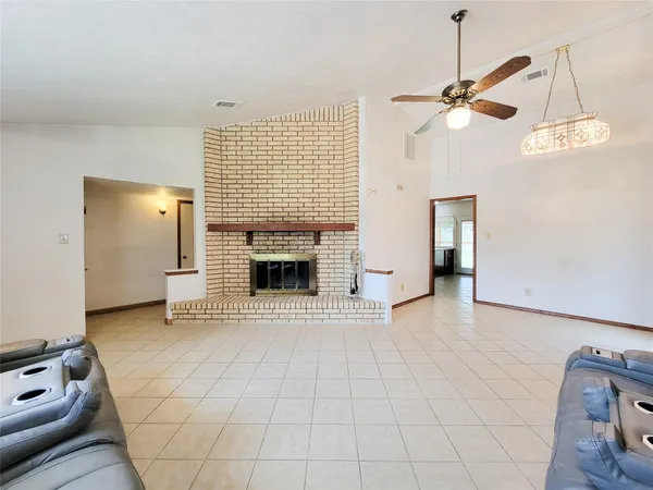 a kitchen with stainless steel appliances granite countertop a stove a sink dishwasher and a microwave oven with large wooden cabinets