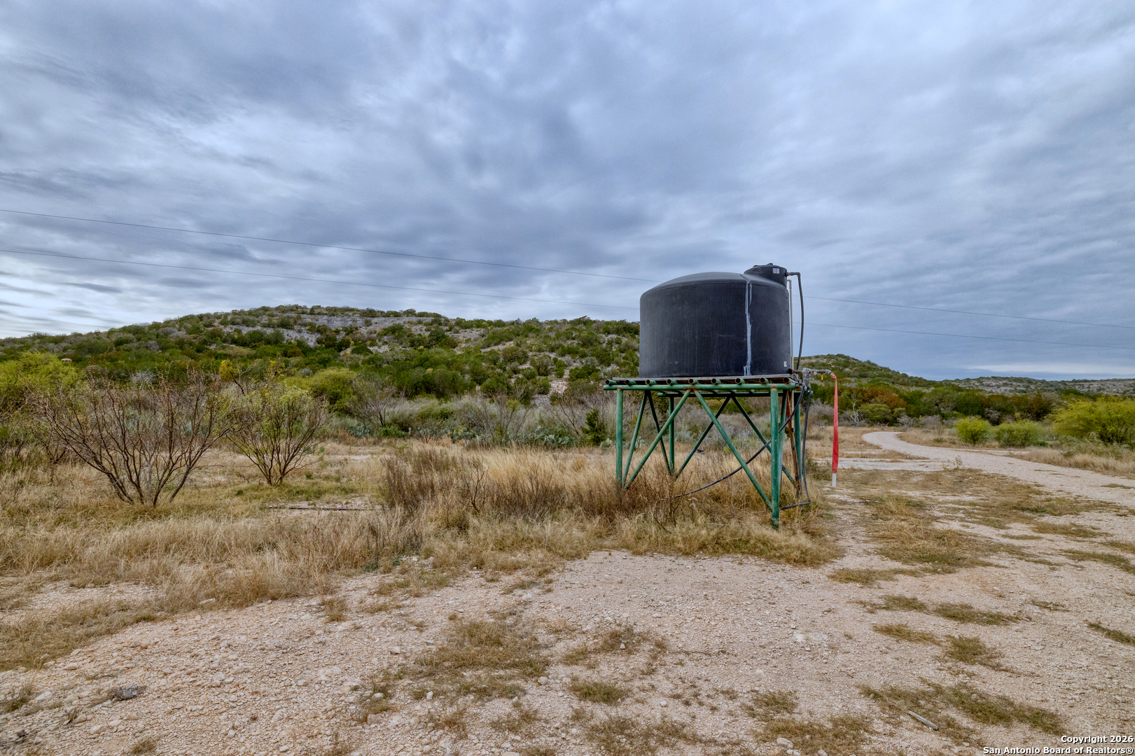 25 Sd 65065 Dusty Rose Ranch Rocksprings, TX 78880 - Photo 47 of 59 a view of a dry yard with wooden fence